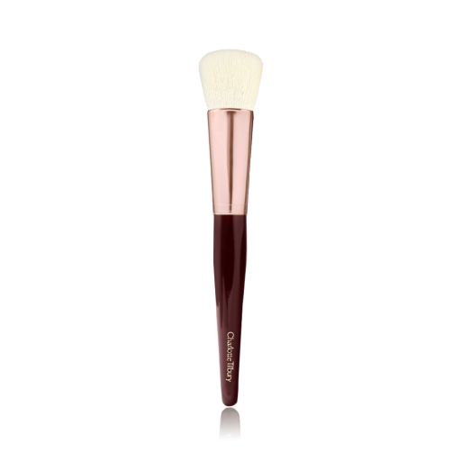A face blending brush with cream-coloured bristles with a rose-gold and dark crimson handle. 
