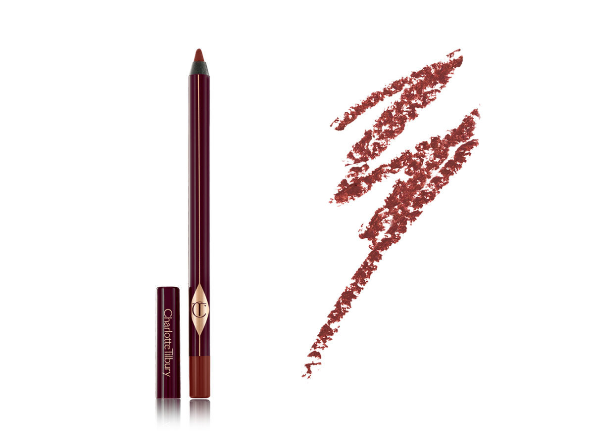 An open eyeliner pencil with its lid next to it in dark crimson packaging along with its dark coppery-red swatch. 