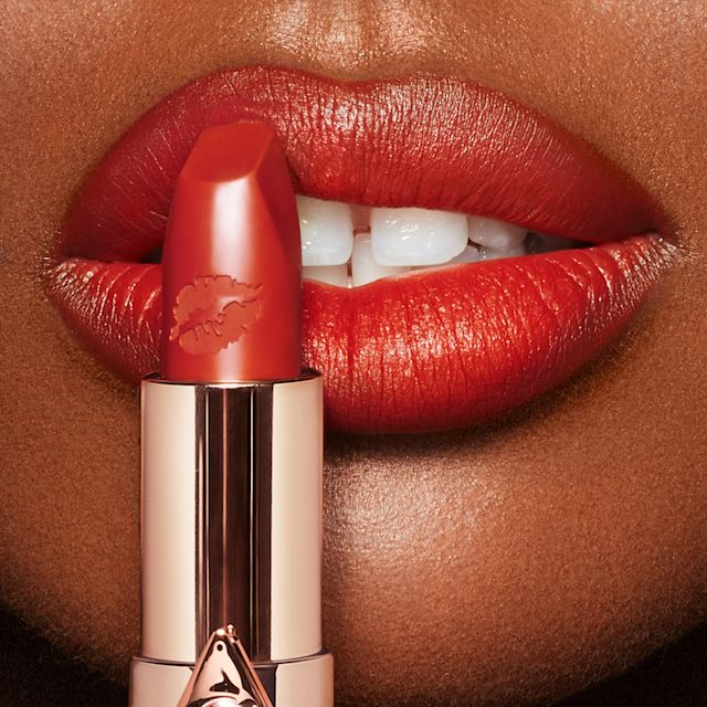 Model wearing Red Hot Susan orange-red Hot Lips lipstick