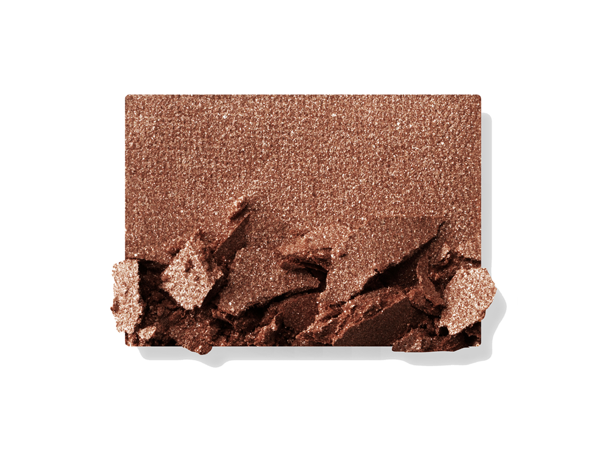 Swatch of a shimmery powder eyeshadow in a dark brown shade. 