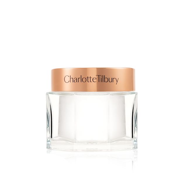 Pearly-white face cream in a glass jar with a gold-coloured lid. 