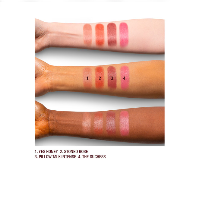 Arm swatches on fair, medium, and dark-tone models of satin-finish lipsticks in nude shades. 