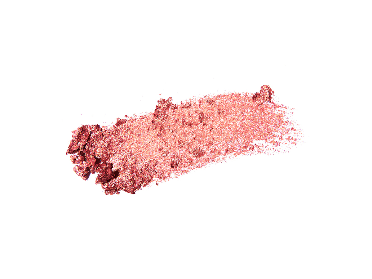 Swatch of an eyeshadow pigment in a berry-pink shade.