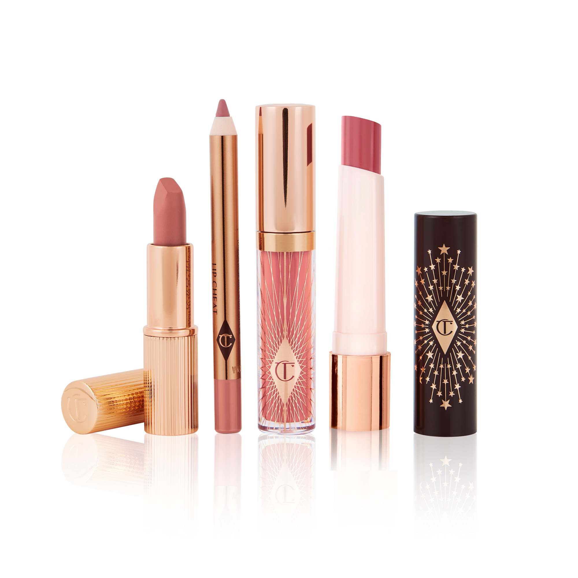 An open, nude pink matte lipstick, lip liner pencil in nude pink, high-shine lip gloss in nude pink, and lipstick balm in rose pink. 