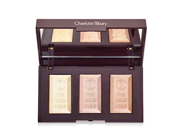 An open, mirrored-lid highlighter palette with three highlighters in white gold, rose gold, and champagne colour. 