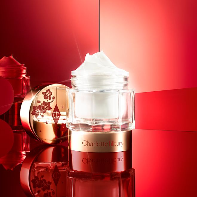 Lunar New Year Magic Cream open Pearly-white cream in a glass jar with a gold-coloured lid with red-coloured tiger stripes illustrated all over for the Lunar New Year.