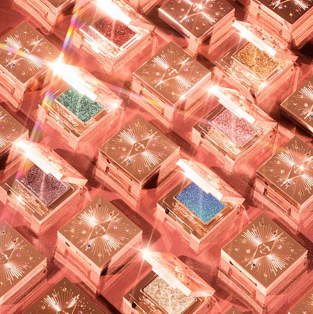 A collection of closed, single-pan, shimmery eyeshadow compacts in rose-gold packaging. 