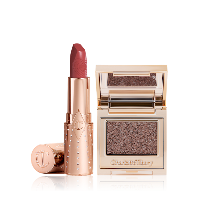 Lip Eyes Hypnotise Kit open An open lipstick in a salmon-pink colour in a gold-coloured tube with a single-pan eyeshadow compact in an iridescent smokey grey eyeshadow with very fine shimmer.