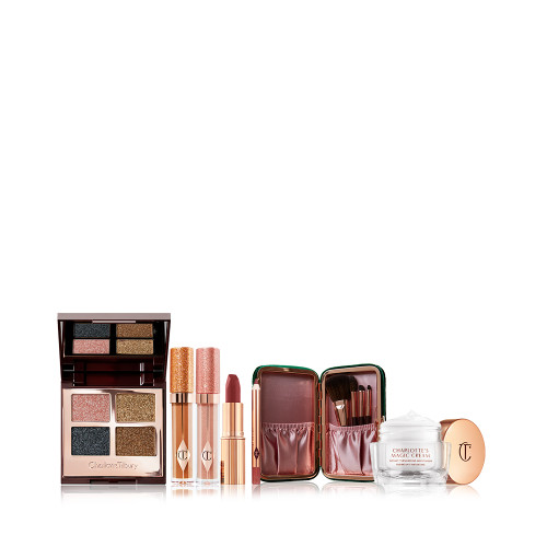  an open, mirrored-lid quad eyeshadow palette with shimmery eyeshadows in rose gold, teal, honey-gold, and bright gold colours, shimmery lip glosses in champagne and pink, lipstick and lip liner pencil in winter-berry, face and eyeshadow brush set with pouch, and pearly-white face cream in a glass jar. 