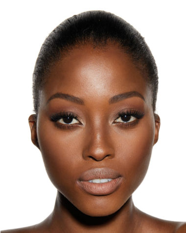 A deep-tone brunette model wearing glowy, nude makeup with bronzed skin. 