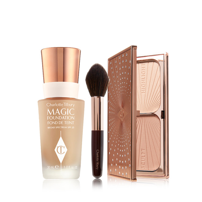 Foundation in a frosted glass bottle with a gold-coloured lid, bronzer and blush brush with soft synthetic bristles, and duo contour palette with highlight and bronzing shades in a sleek, gold-coloured compact.