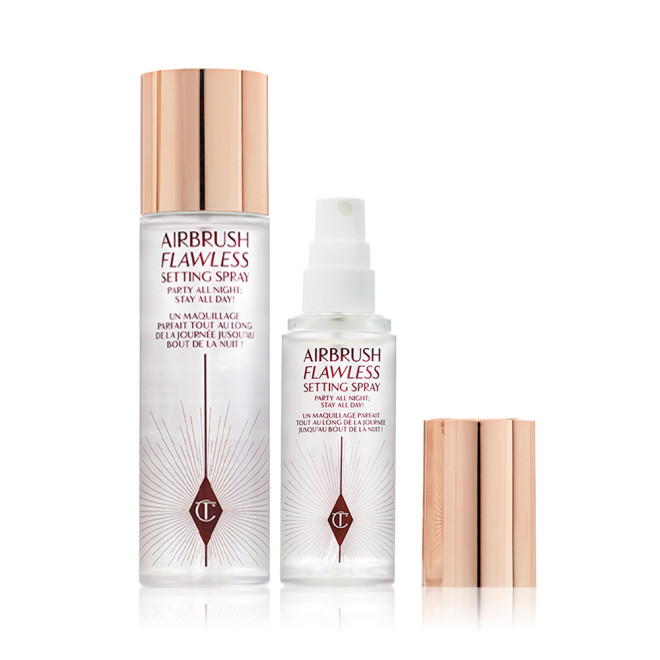 Travel-size and full-size setting spray in clear bottles with gold-coloured lids.
