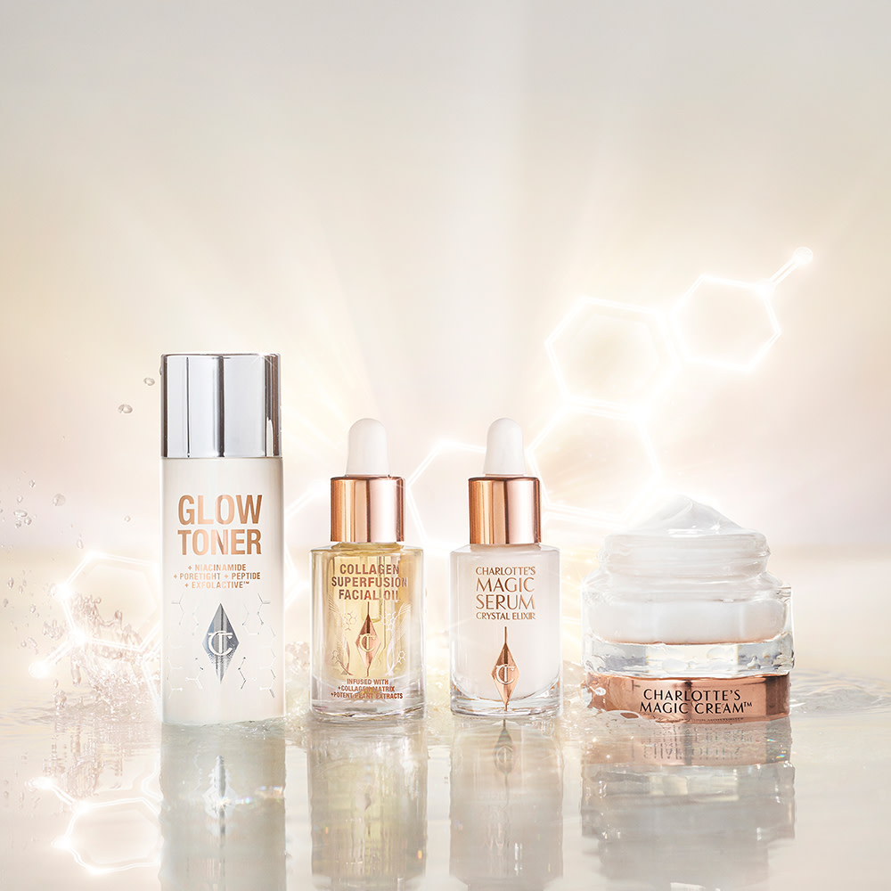  A watery, silvery-white toner in a large bottle, ivory-coloured luminous serum in a glass bottle, light gold-coloured facial oil in a glass bottle, and a pearly-white face cream in a glass jar with a gold-coloured lid.