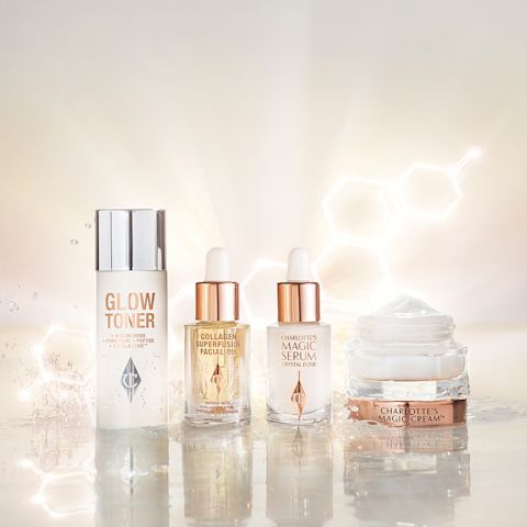  A watery, silvery-white toner in a large bottle, ivory-coloured luminous serum in a glass bottle, light gold-coloured facial oil in a glass bottle, and a pearly-white face cream in a glass jar with a gold-coloured lid.