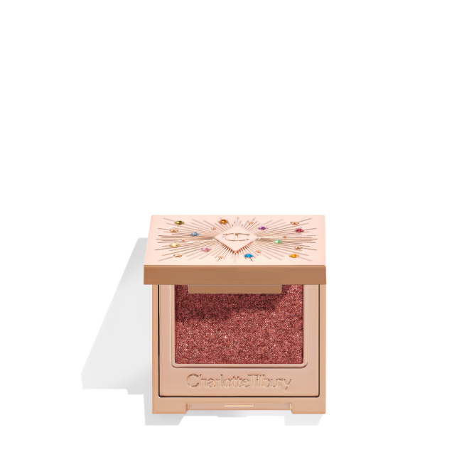 An open, single-pan eyeshadow with a mirrored lid in an iridescent rustic red shade with very fine shimmer. 