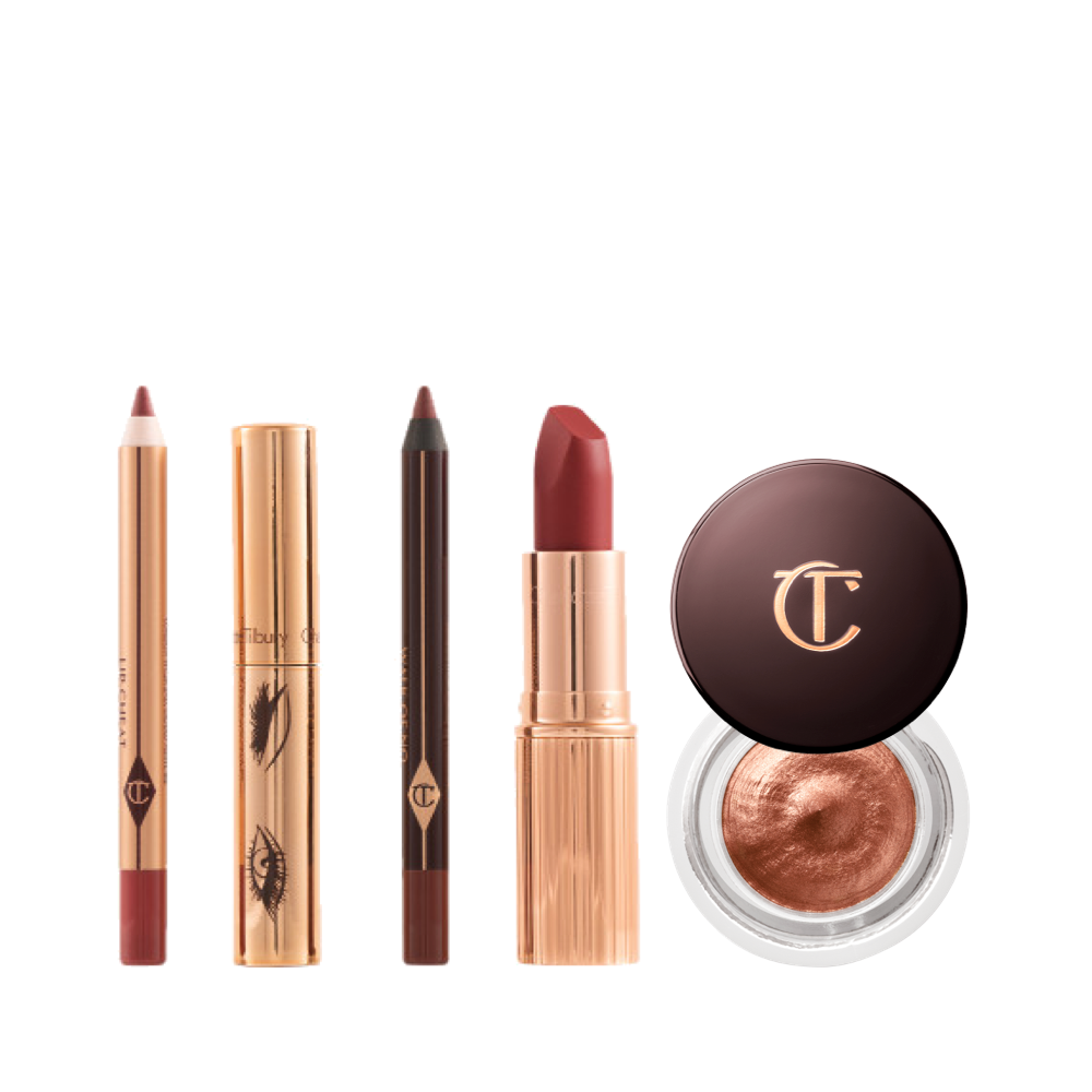 An open lip liner pencil in berry rose, mascara in a gold-coloured tube, lip liner pencil in a berry rose shade, matte lipstick in a berry red shade in a gold-coloured tube, and cream eyeshadow in a russet rose shade with gold sparkle.