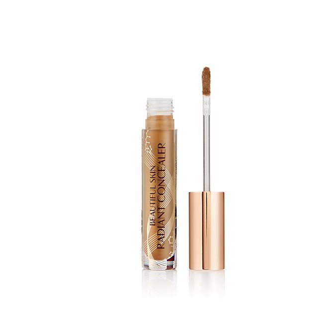 Radiant concealer in a glass tube with its doe-foot applicator next to it with a gold-coloured handle.