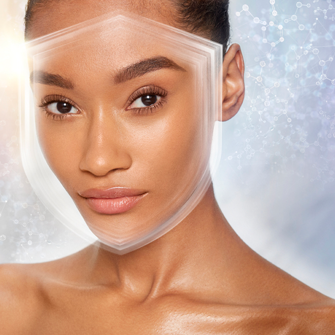 Deep-tone model wearing a smoothing primer with a satin-finish with an illusion of a shield over her face to depict protection from UV rays.