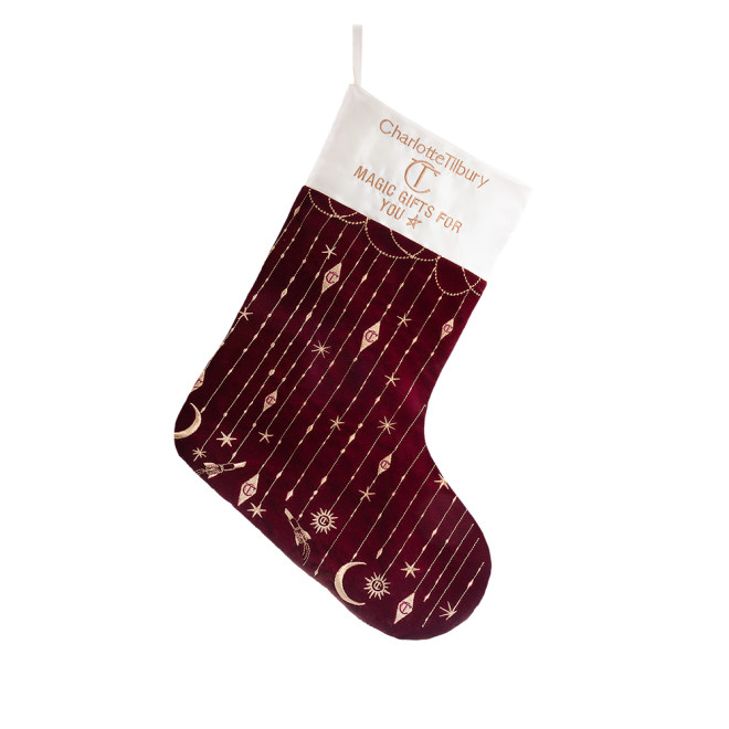 Maroon-coloured holiday stocking with gold details and an ivory-coloured border.