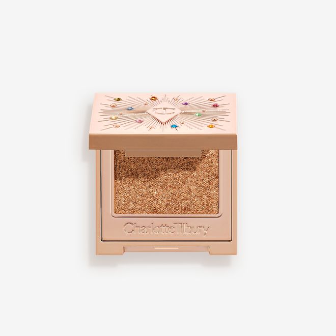 Hypnotising Pop Shot in Sunlit Diamond open An open, single-pan eyeshadow with a mirrored lid in an iridescent orange-gold shade with very fine shimmer.