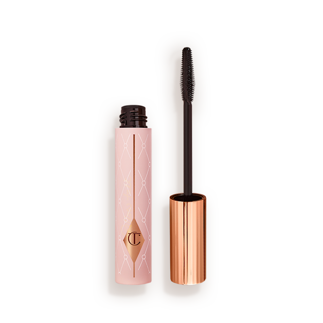 Pillow Talk Mascara open Mascara in a pink-coloured tube with its gold-coloured lid with a black applicator next to it.