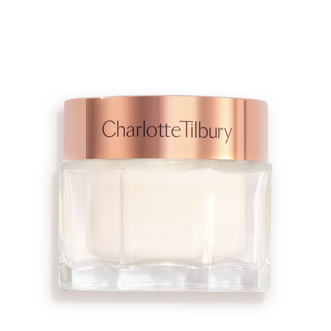 Charlotte's Magic Cream closed Pearly-white face cream in a glass jar with a gold-coloured lid with text on it, 'Charlotte's magic cream'.