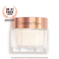Pearly-white face cream in a glass jar with a gold-coloured lid with text on it, 'Charlotte's magic cream'.