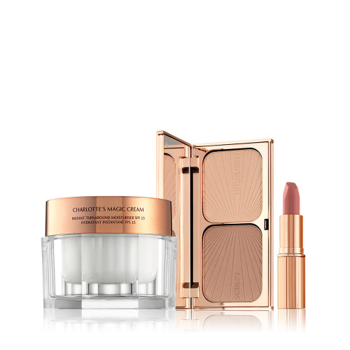 A moisturising face cream in a glass jar with a rose-gold coloured lid, a face contour palette with a mirrored-lid, and a nude-pink lipstick in a golden-coloured tube. 