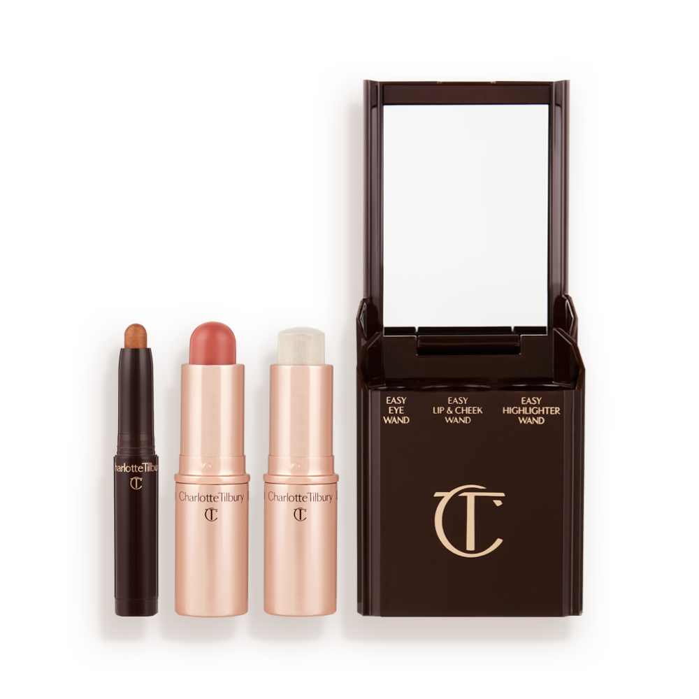 An open shadow stick in a shimmery bronze shade, lip and cheek blush stick in a nude-rose shade, and highlighter stick in an opal shade.