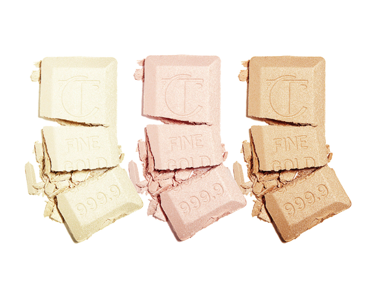 Swatches of three powder highlighters in shades of white gold, rose gold, and golden. 