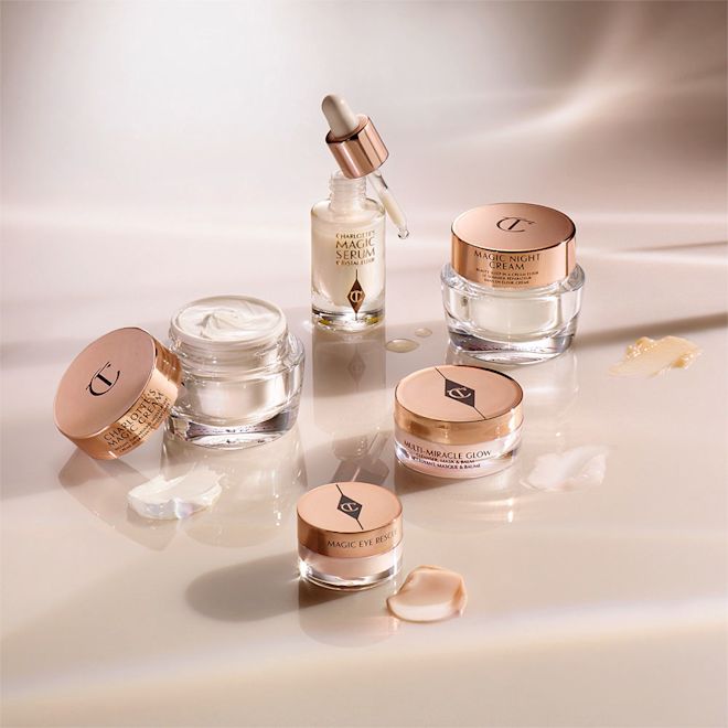 Glowing Skincare Starter Kit displayed Banner with a cleansing balm in a glass jar, facial serum in a glass bottle and its dropper lid next to it, eye cream, day, and night creams in glass jars with gold-coloured lids.