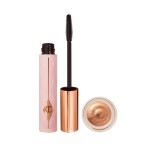 An open, black-coloured mascara in a pink-coloured tube with cream eyeshadow in rose gold shade in a glass pot.