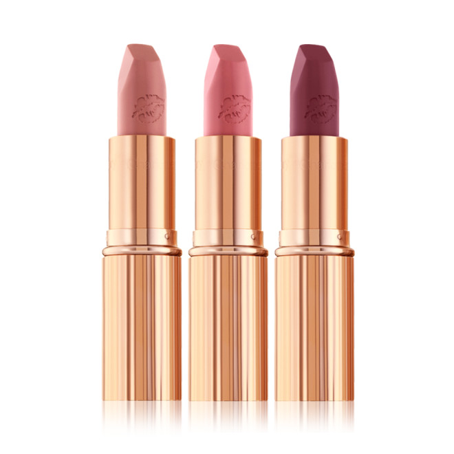 three matte lipsticks with their lids removed in nude peach, tea rose, and purplish-pink colours. 