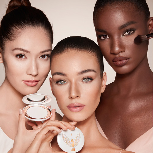 Three models of light, medium and deep skin wearing a radiant, setting powder that brightens, covers blemishes, and makes their skin look fresh, 