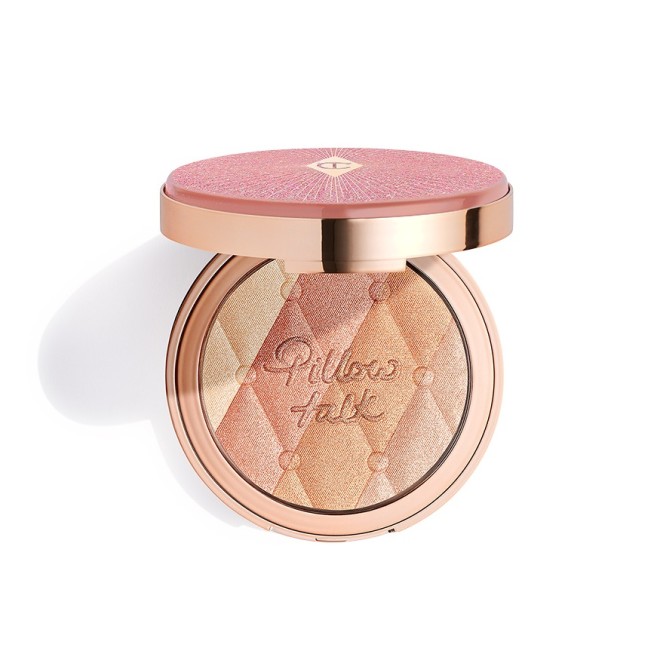 An open, pressed powder highlighter compact, with a mirrored-lid, in various shades of pink and gold for warm-tone complexions. 