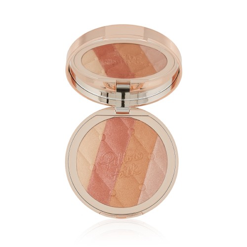 An open, pressed powder highlighter compact, with a mirrored-lid, in various shades of pink and gold for warm-tone complexions. 