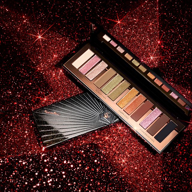 Red and black-coloured galaxy-theme banner with an open and closed, 12-pan eyeshadow palette with matte and shimmery shades in beige, pink, gold, green, brown, peach, and black.