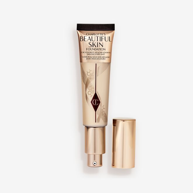 Beautiful Skin Foundation in 2N open An open foundation wand in gold packaging with a pump dispenser and a medium-beige-coloured body to show the shade of the foundation inside.