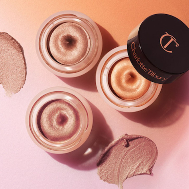 Three, petite, open pots filled with shimmery cream eyeshadows in nude, bronze, and rose gold.