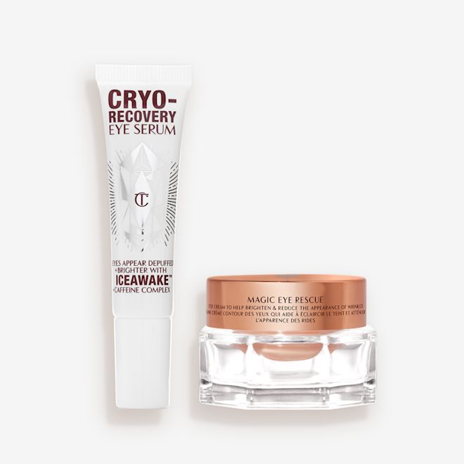 Eye Skincare Duo open An open, white-coloured eye serum tube with silver-colour geometric patterns on the front and text written on it that reads, 'eye appear depuffed and brighter with Iceawake, caffeine complex' and an open, champagne-coloured thick, eye cream in a glass pot with a gold-coloured lid.