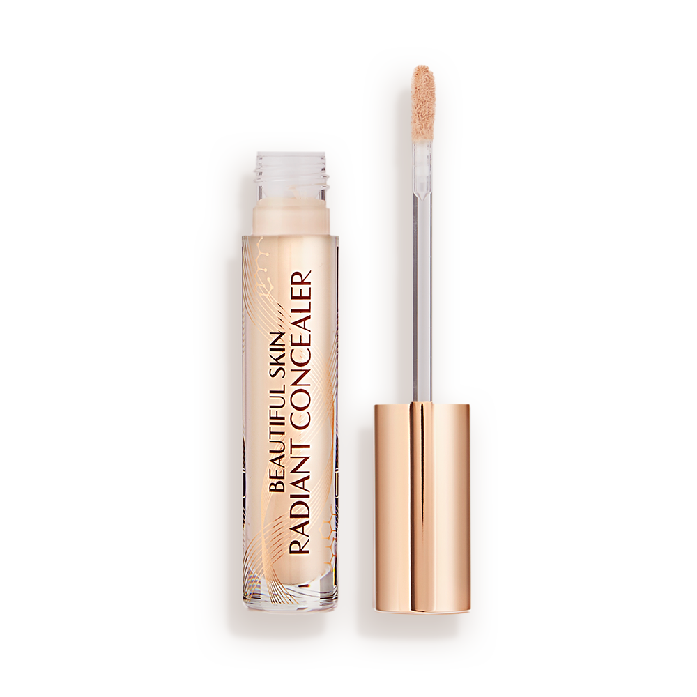 Radiant concealer in a glass tube with its doe-foot applicator next to it with a gold-coloured handle.