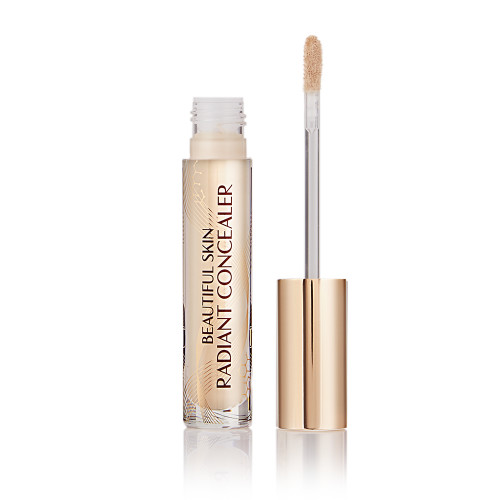Radiant concealer in a glass tube with its doe-foot applicator next to it with a gold-coloured handle.