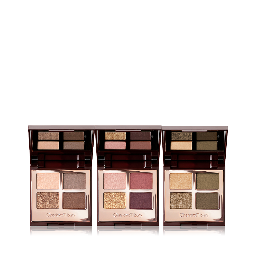 Three, open, quad eyeshadow palettes with mirrored-lids in matte and shimmery gold, beige, brown, red, purple, and green shades.