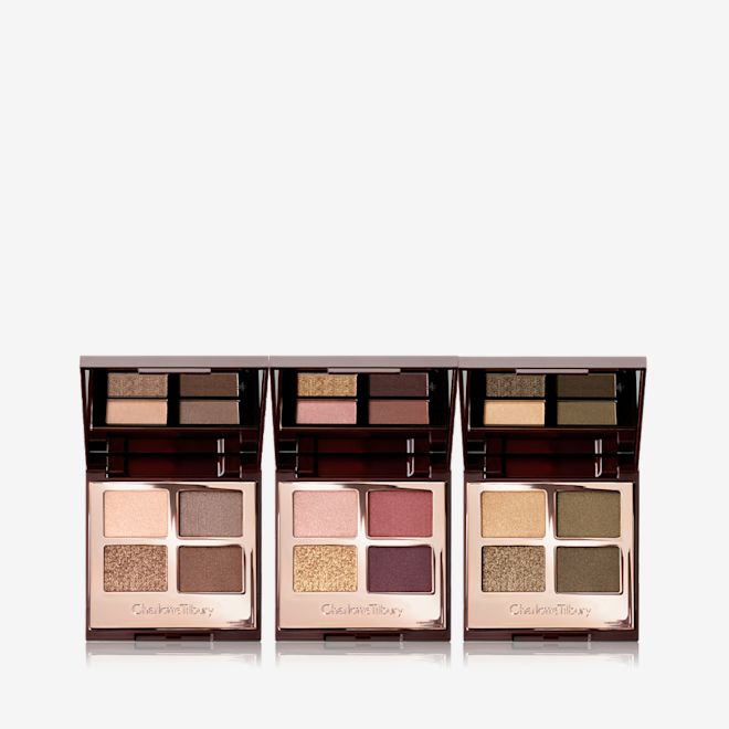 Luxury Palette Eyeshadow Trio open Three, open, quad eyeshadow palettes with mirrored-lids in matte and shimmery gold, beige, brown, red, purple, and green shades.