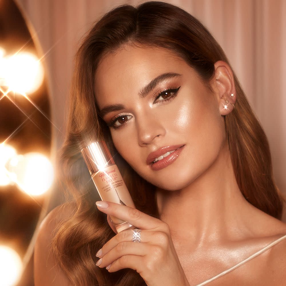 Lily James with Charlotte's iconic glow booster Hollywood Flawless Filter