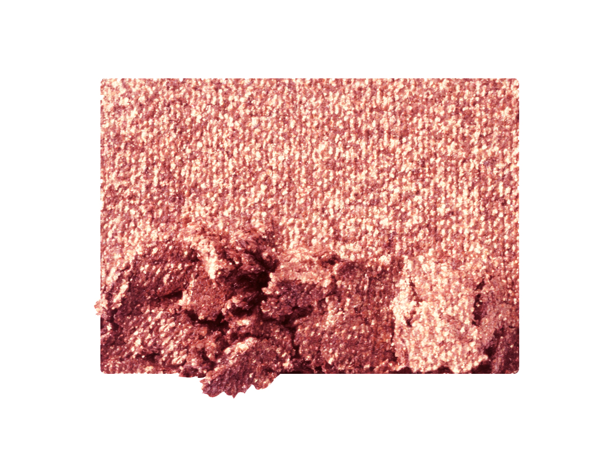 Swatch of a shimmery rose gold eyeshadow.
