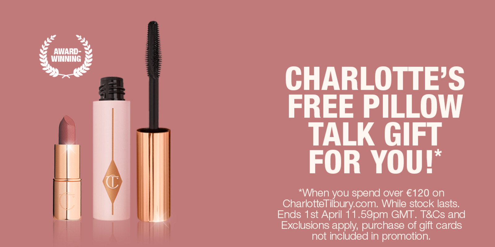 A dark nude pink-themed banner with an open mascara and open lipstick on it along with text that reads, 'Charlotte's free pillow talk gift for you! When you spend over £90 on charlotte tilbury dot com. While Stock lasts. Shop now!