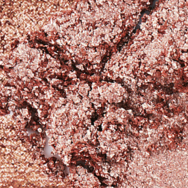 Swatch of an iridescent rose gold eyeshadow with very fine shimmer. 
