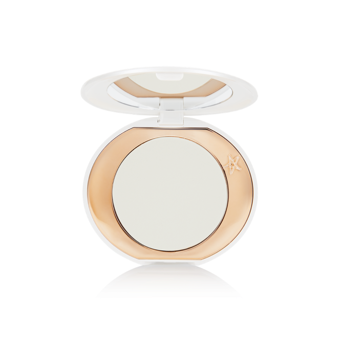 A miniature compact brightening powder in a white shade for fair and medium skin tones.