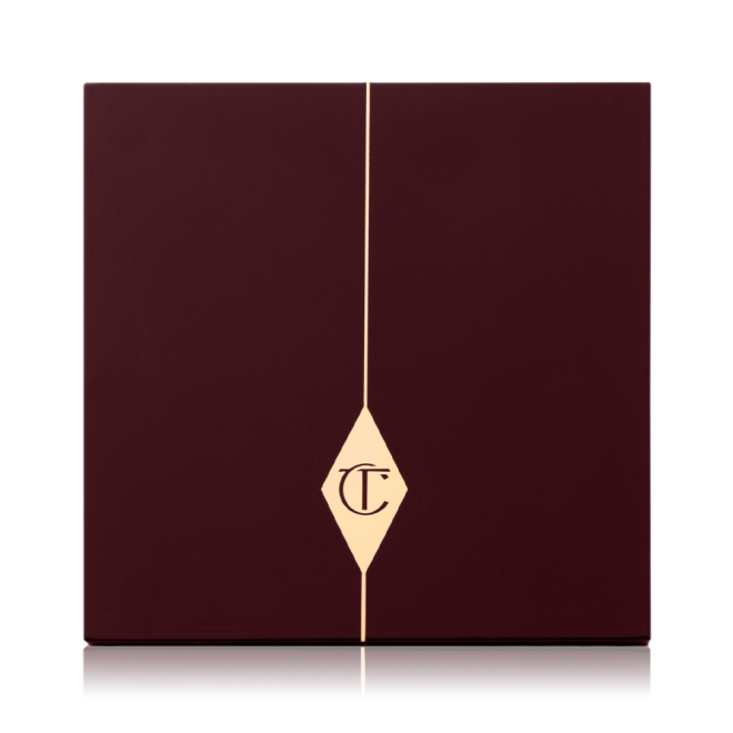 A closed face palette with a dark brown-coloured lid with the iconic CT logo printed on the front in gold colour.